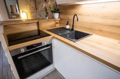 a kitchen with a sink and a stove at Appartement très cosy avec cour in Cannes