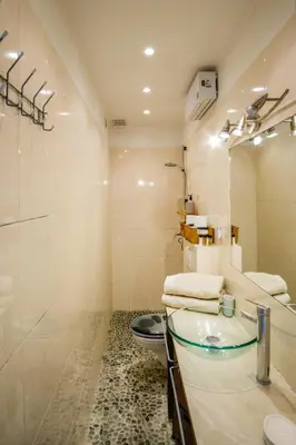 a bathroom with a sink and a toilet at Appartement très cosy avec cour in Cannes