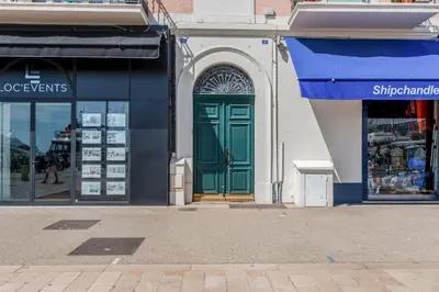 a green door on the side of a building at Appartement Immaculia - Welkeys in Cannes