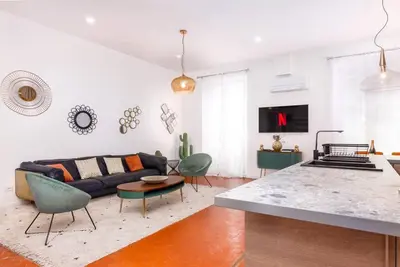 a living room with a couch and a table at Luxury 3 Bd Aptment with Sea view in Cannes