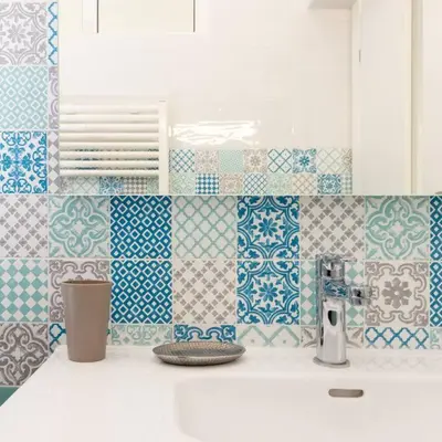 a kitchen with blue and white tiles on the wall at Luxury 3 Bd Aptment with Sea view in Cannes