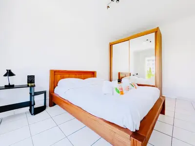 a bedroom with two beds and a mirror at L'Oasis - 3 Pièces centre Cannes in Cannes