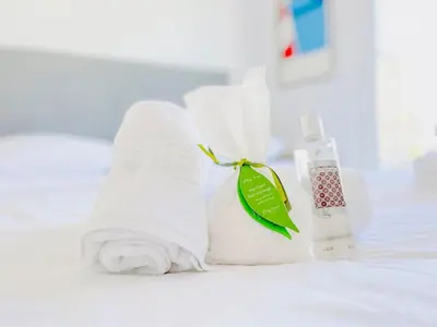 a pile of towels and a bottle of toothpaste at L'Oasis - 3 Pièces centre Cannes in Cannes
