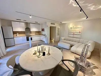 a living room with a table and chairs and a couch at CAM0 - appartement 2 chambres en rez-de-terrasse in Cannes
