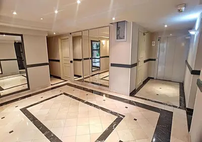 a lobby with a row of elevators in a building at CAM0 - appartement 2 chambres en rez-de-terrasse in Cannes