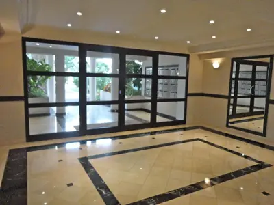 a room with a large window and a tile floor at CAM0 - appartement 2 chambres en rez-de-terrasse in Cannes