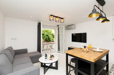 a living room with a couch and a table at Cyclades YourHostHelper in Cannes