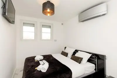 a bedroom with a bed with two teddy bears on it at Cyclades YourHostHelper in Cannes