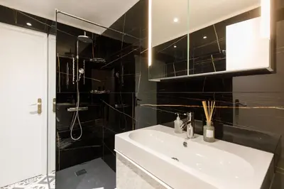a bathroom with a sink and a shower at Cyclades YourHostHelper in Cannes