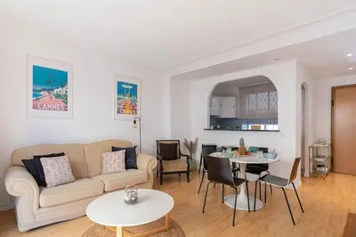 a living room with a couch and a table at Le Vautrin - Charmant Appartement à 300 mètres des plages de la Croisette in Cannes
