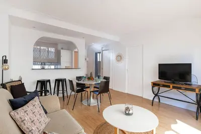 a living room with a couch and a table at Le Vautrin - Charmant Appartement à 300 mètres des plages de la Croisette in Cannes