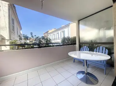a balcony with a table and two chairs on it at Cannes - Studio en plein cœur de Cannes in Cannes
