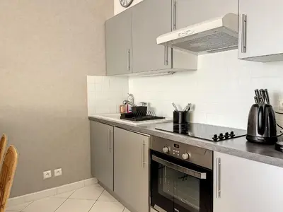 a kitchen with a sink and a stove top oven at Cannes - Studio en plein cœur de Cannes in Cannes