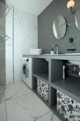 a bathroom with a sink and a washing machine at Appartement 5 min des plages Croisette in Cannes