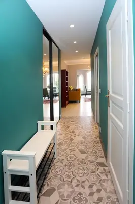 a hallway with a bench and a blue wall at Appartement 5 min des plages Croisette in Cannes