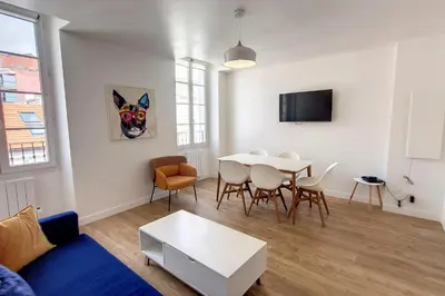 a living room with a table and a dining room at HENRI CAMILLE REAL ESTATE - Bambou- One bedroom apt downtown in Cannes