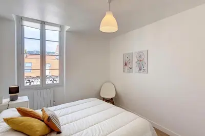 a white bedroom with a bed and a window at HENRI CAMILLE REAL ESTATE - Bambou- One bedroom apt downtown in Cannes