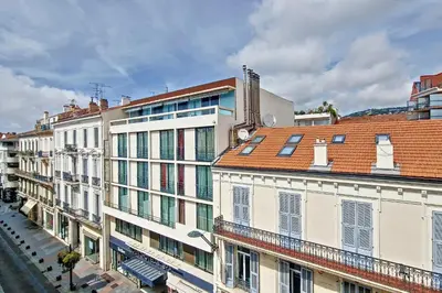 a group of buildings on a city street at HENRI CAMILLE REAL ESTATE - Bambou- One bedroom apt downtown in Cannes