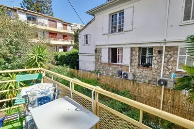 a balcony with a table and a building at HENRI CAMILLE REAL ESTATE- Santiago - 2 bedrooms close Croisette in Cannes