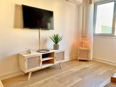 a living room with a flat screen tv on a wall at PACA Properties 57A - Studio cosy in Cannes