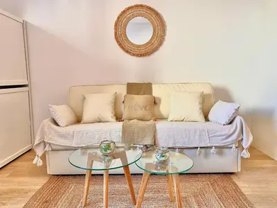 a living room with a couch and a glass table at PACA Properties 57A - Studio cosy in Cannes