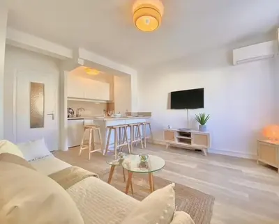 a living room with a couch and a table at PACA Properties 57A - Studio cosy in Cannes