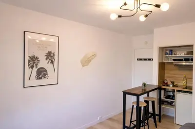 a kitchen with a table and a picture on the wall at Studio centre de Cannes in Cannes