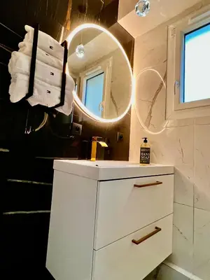 a bathroom with a white vanity and a mirror at Palais 5min Luxury&Cinema Studio in Cannes