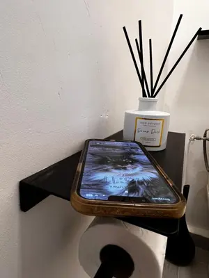 a tablet sitting on top of a toilet paper roll at Palais 5min Luxury&Cinema Studio in Cannes