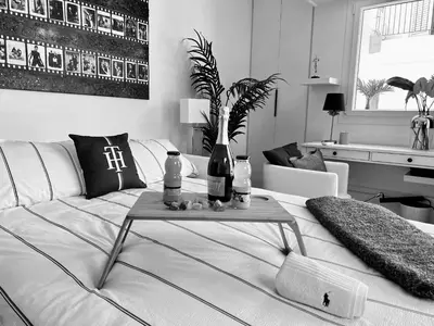 a living room with a bed with a table on it at Palais 5min Luxury&Cinema Studio in Cannes