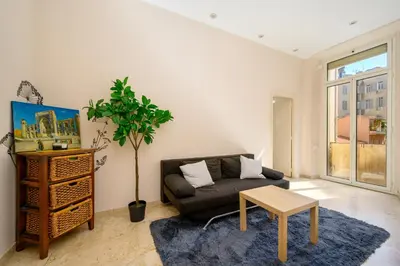 a bedroom with a bed with a wrought iron headboard at Résidence Raphaël Croisette in Cannes
