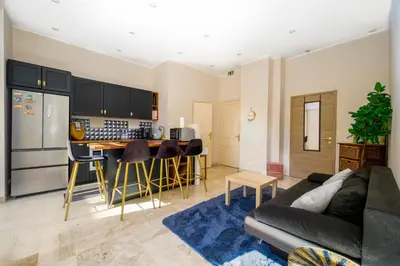a kitchen with a wooden counter top and a refrigerator at Résidence Raphaël Croisette in Cannes