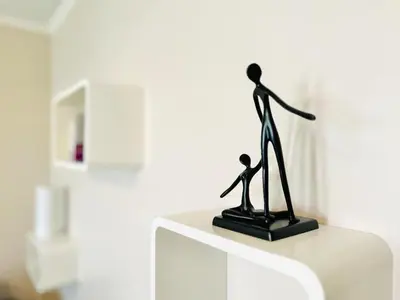 a statue of two people sitting on a shelf at L'Azur - Appartement 2 chambres - Terrasse in Cannes
