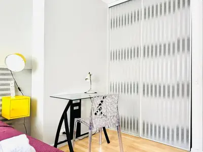 a table and a chair in a room with a window at L'Azur - Appartement 2 chambres - Terrasse in Cannes