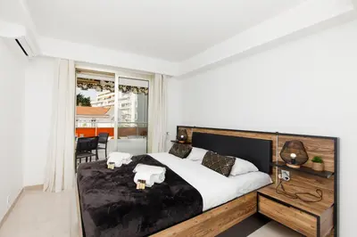 a bedroom with a large bed with two towels on it at Les Liserons YourHostHelper in Cannes