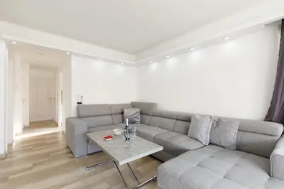 a living room with a couch and a table at Les Liserons YourHostHelper in Cannes