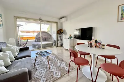 a living room with a couch and a table at Beautiful flat with terrace near Croisette in Cannes