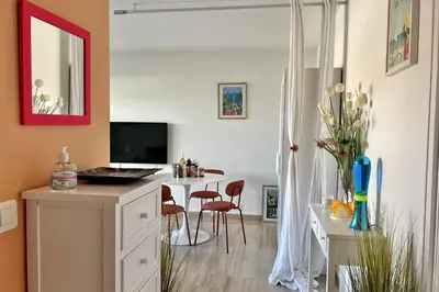 a room with a desk with a computer and chairs at Beautiful flat with terrace near Croisette in Cannes