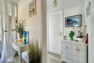 a white room with a white dresser and a mirror at Beautiful flat with terrace near Croisette in Cannes