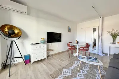 a living room with a table and a couch at Beautiful flat with terrace near Croisette in Cannes