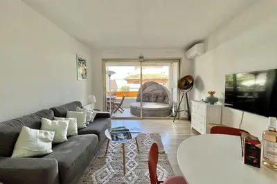 a living room with a couch and a table at Beautiful flat with terrace near Croisette in Cannes