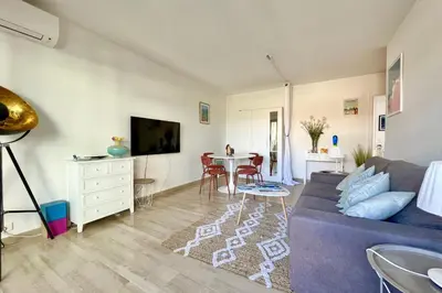 a living room with a couch and a table at Beautiful flat with terrace near Croisette in Cannes