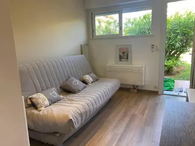 a living room with a couch and a window at Studio CANNES PARC CROISETTE in Cannes