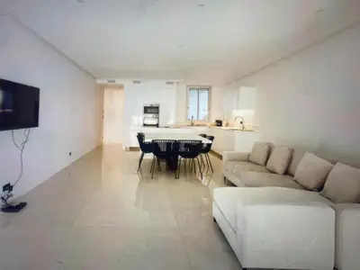 a living room with a couch and a table at Appartement Avec Terrasse Centre-ville Croisette in Cannes