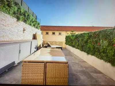 a balcony with two benches and a wall with plants at Appartement Avec Terrasse Centre-ville Croisette in Cannes