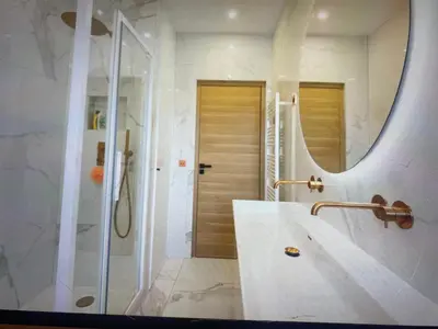 a bathroom with a shower and a sink and a mirror at Appartement Avec Terrasse Centre-ville Croisette in Cannes