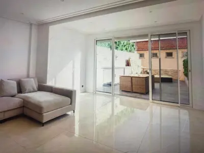a living room with a couch and a large window at Appartement Avec Terrasse Centre-ville Croisette in Cannes
