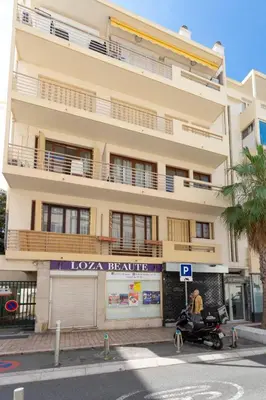 a person on a scooter in front of a building at WE CANNES ! Cosy 2-bedroom apartment with terrace Cannes Center in Cannes