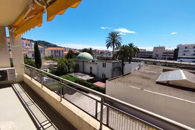 a balcony with a view of a city at WE CANNES ! Cosy 2-bedroom apartment with terrace Cannes Center in Cannes