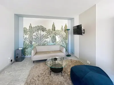 a living room with a couch and a glass table at Appartement Canto bright appartement Croisette beach in Cannes